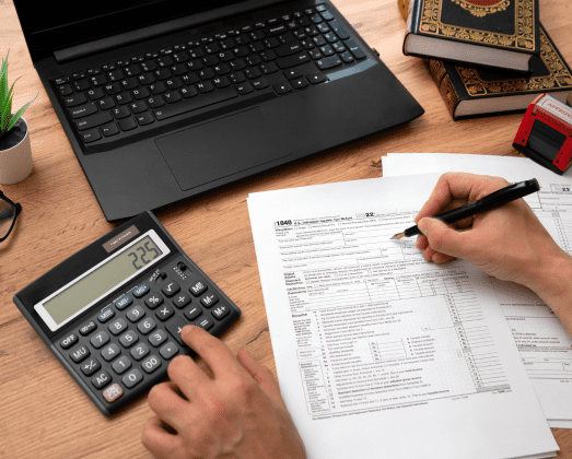 Tax papers with calculator and laptop