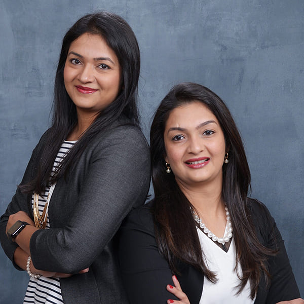 Photo of two sisters in professional attire